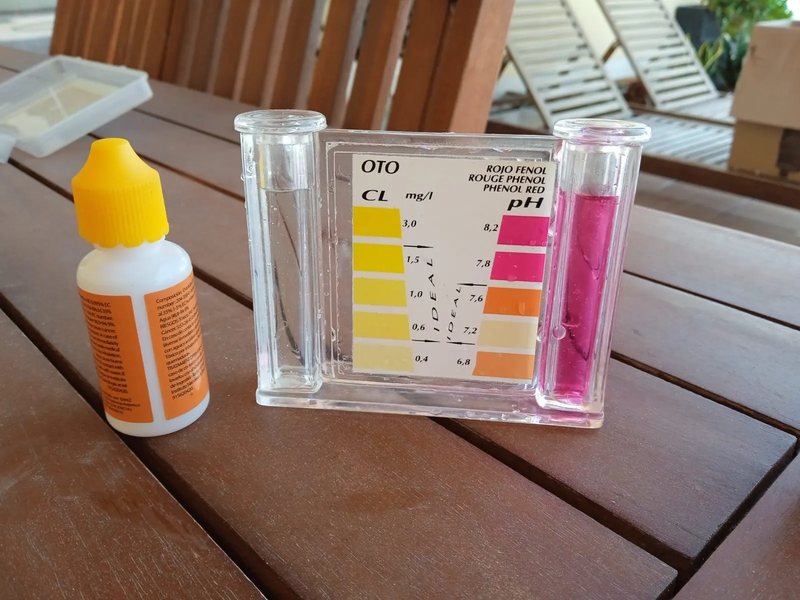 Pool water test kit measuring pH and chlorine at the poolside