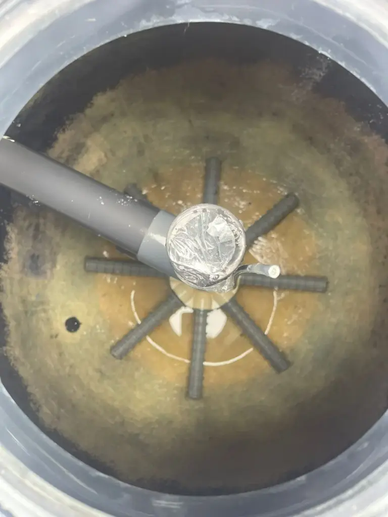 Inside a pool sand filter with the laterals visible during an inspection