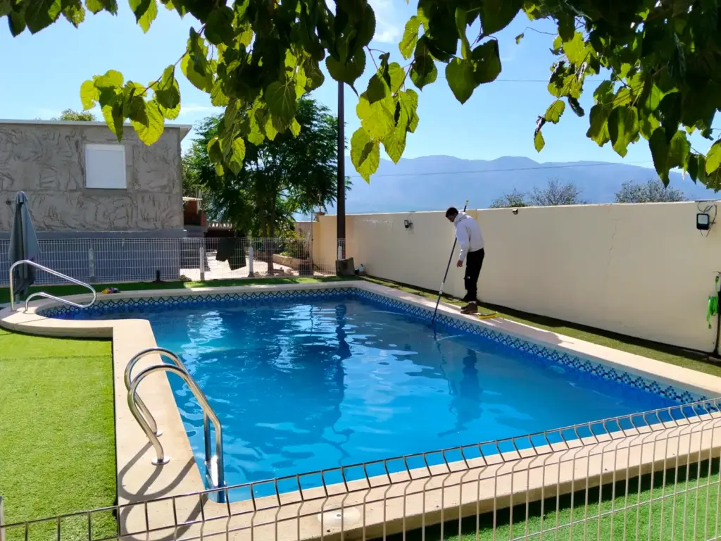 A private pool with clear water after cleaning and replacing the filter media